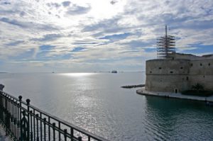 boats are waiting outside the harbor of taranto (italy)